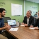 An employee speaks with his superiors about a project in a relaxed environment
